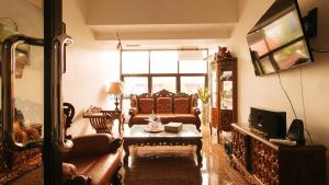 a living room with a couch and a tv at RedDoorz near LRT 2 Antipolo Station in Antipolo