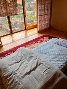 Postel nebo postele na pokoji v ubytování 町中ステイ 宗ハウス