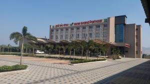 a large building with a sign on top of it at Hotel Grand Parivaar in Igatpuri