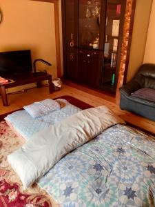 Postel nebo postele na pokoji v ubytování 町中ステイ 宗ハウス