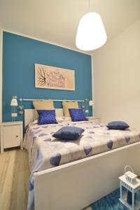 a bedroom with a large bed with blue walls at Dimora Pascali - "Home & Breakfast" in Polignano a Mare