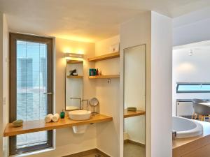 a bathroom with a sink and a tub and a toilet at Alectrona Living Crete, Apartment RocSea in Plataniás