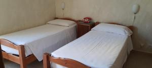 Ένα ή περισσότερα κρεβάτια σε δωμάτιο στο Albergo Avalon