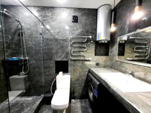 a bathroom with a shower and a toilet and a sink at Исы Байзакова 133 in Pavlodar