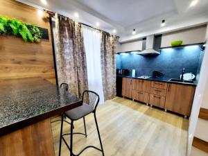 a kitchen with a black counter top and a table at Исы Байзакова 133 in Pavlodar +13 photos