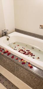 a bath tub filled with lots of petals at Hotel First (Adult Only) in Ikeda