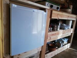 a dishwasher in a kitchen next to a shelf at Wooden House at the Mountain-private in Paránimfoi