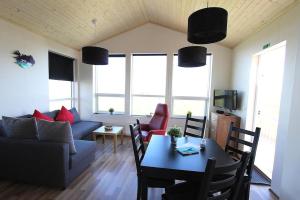 a living room with a couch and a table at Blue View Cabin 1A With private hot tub in Reykholt