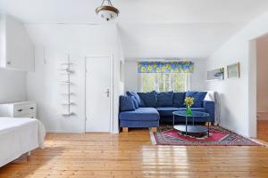 a living room with a blue couch and a table at Charming 3BR country house near Piteå & Skellefteå in Piteå