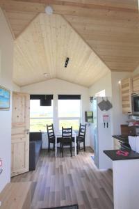 a kitchen and dining room with a table and chairs at Blue View Cabin 4B With private hot tub in Reykholt