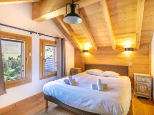 a bedroom with a large bed in a wooden room at Vacancéole - Résidence La Résidence in Les Deux Alpes