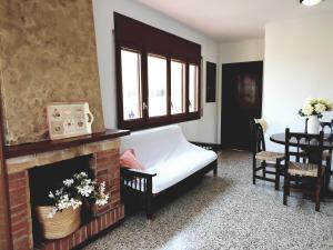 a living room with a bed and a fireplace at Xaloc, apartament amb vistes a mar M4 in Port de la Selva +9 photos