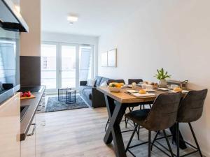 a kitchen and living room with a table and chairs at Hafenspitze App 10 in Wismar