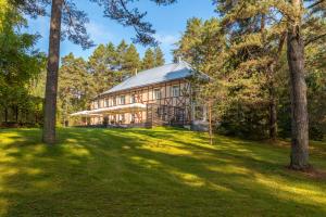 a large house in the woods with trees at Verevi Motel in Elva