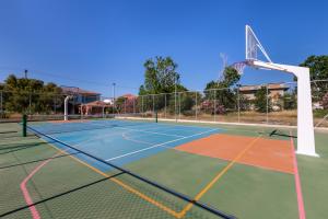 a tennis court with a basketball hoop at White Olive Premium Laganas in Laganas