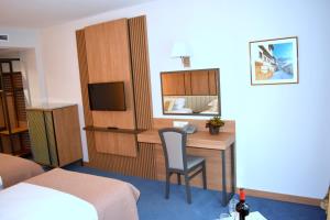 a hotel room with a desk and a bed at Legends Hotel in Sofia