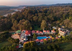an aerial view of a house with a swimming pool at Country Inn Tarika Riverside Resort Jim Corbett in Garjia