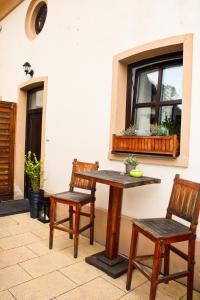 a table and two chairs sitting next to a window at Pension U Hastrmana in Prague