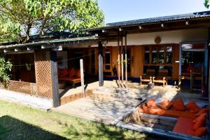 a house with an outdoor patio with orange couches at Mermaid Beach Resort in Dhoāpālong
