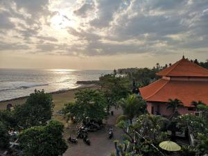 a beach with palm trees and palm trees at Udara Bali Yoga Detox & Spa in Canggu