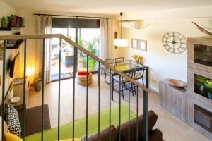 a room with a spiral staircase and a living room at Casa Falset in L'Estartit