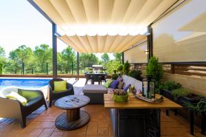 a patio with a table and chairs and a pool at Casa Falset in L'Estartit