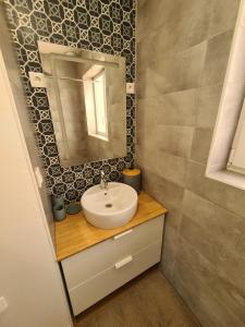 a bathroom with a sink and a mirror at Le calme de la nature à 8 minutes des plages in Sémussac