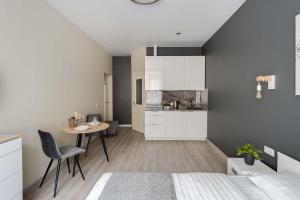 um quarto com uma cama, uma mesa e uma cozinha em Knokey Басманный em Moscovo