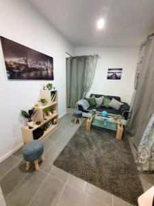 a living room with a couch and a rug at Appartement d'une chambre avec vue sur la ville jardin clos et wifi a Dijon in Dijon
