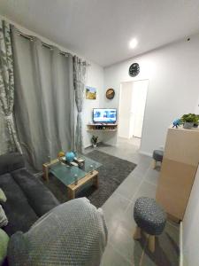 a living room with a couch and a table at Appartement d'une chambre avec vue sur la ville jardin clos et wifi a Dijon in Dijon