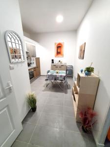 a living room with a table and a dining room at Appartement d'une chambre avec vue sur la ville jardin clos et wifi a Dijon in Dijon