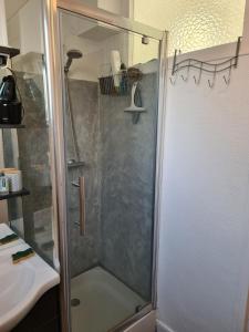 a bathroom with a shower, sink, and toilet at Private room I in Beauvais