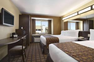 Ένα ή περισσότερα κρεβάτια σε δωμάτιο στο Microtel Inn & Suites by Wyndham Odessa TX