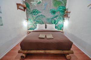 a bedroom with a bed with two boxes on it at Snooze in Yogyakarta