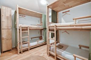 a room with three bunk beds in a dorm at Snooze in Yogyakarta