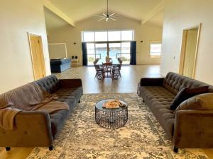 a living room with two couches and a table at Emu Bay Lodge in Emu Bay