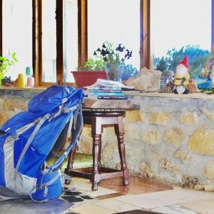 a small table with a stroller next to a table with a strollerngth at Nomad Hostel in Nimrod