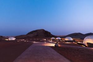 a group of domes in the desert at night at Mysk Moon Retreat in Sharjah