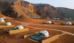 a group of domes in a desert with a mountain at Moon Retreat by Sharjah Collection in Sharjah