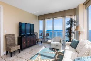 a living room with a couch and a flat screen tv at Island Tower in Gulf Shores