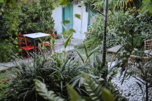 a garden with two red chairs and a table at Snooze in Yogyakarta