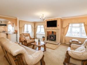 a living room with couches and a fireplace at The Chalet in Northallerton