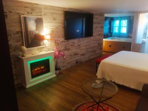 a bedroom with a bed and a fireplace at Hotel Boutique Real Posada De Liena y Restaurante Liena in Murillo de Gállego