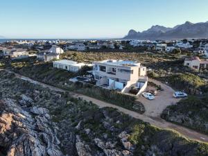 an aerial view of a white house on a hill at Villa Marine Guest House in Pringle Bay