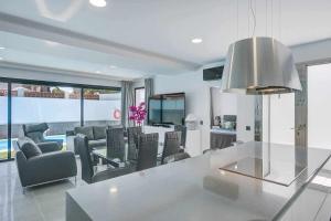 a kitchen and living room with a table and chairs at Two Dreams Luxury Villa in Corralejo