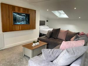 a living room with a couch and a bed at Woodroyd apartments in Luddenden Foot