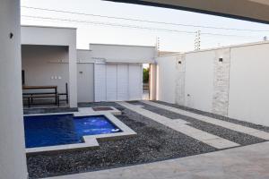 a swimming pool in the middle of a house at Casa Marilago in Camocim