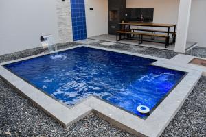a pool with a water feature in the middle of a house at Casa Marilago in Camocim