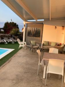 a patio with tables and chairs next to a swimming pool at LA ERA 2 in Cotillo