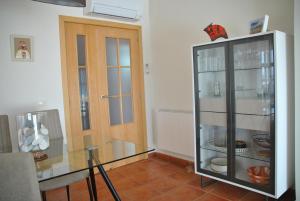 a kitchen with a glass table and a door at Rincón de Vera - Ático in Vera